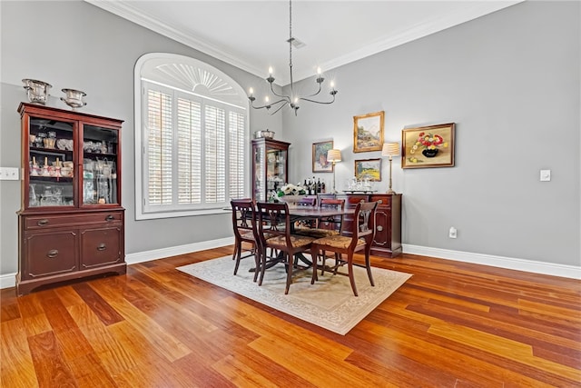 1939 Windway Rd, Auburn, AL 36830 - dining area featuring baseboards, a chandelier, ornamental molding, and wood finished floors