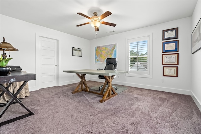 carpeted office space with ceiling fan