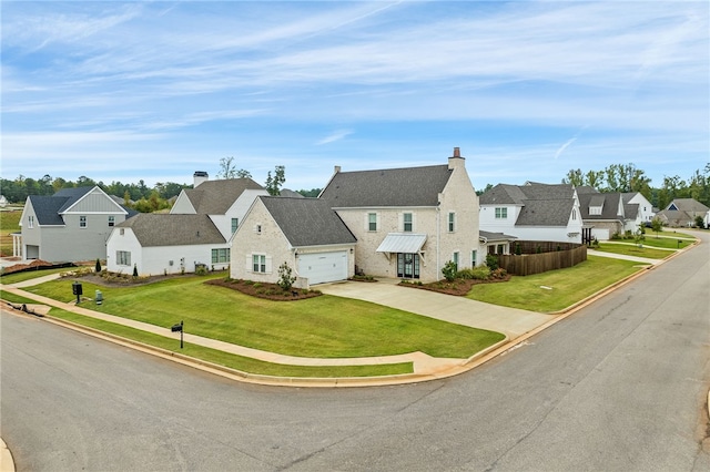 view of front of property featuring a garage and a front yard