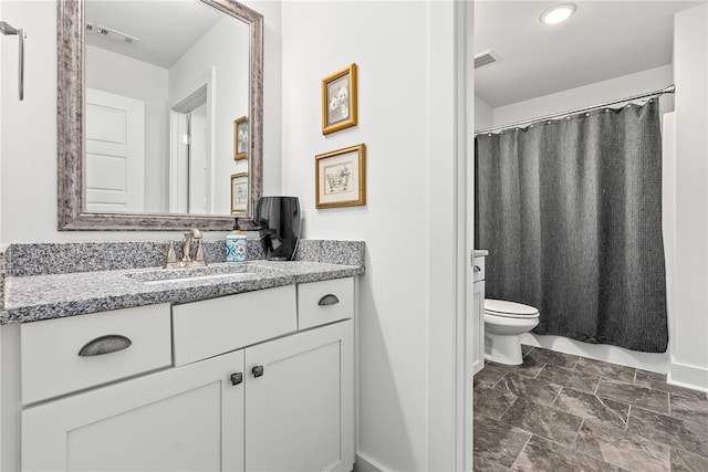 bathroom with vanity and toilet