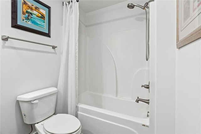 bathroom featuring shower / bath combination with curtain and toilet