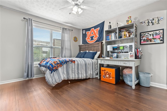 bedroom with hardwood / wood-style floors, ceiling fan, and a textured ceiling