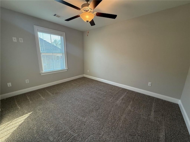 empty room featuring dark carpet and ceiling fan