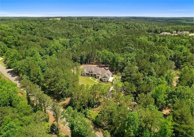 birds eye view of property with a view of trees