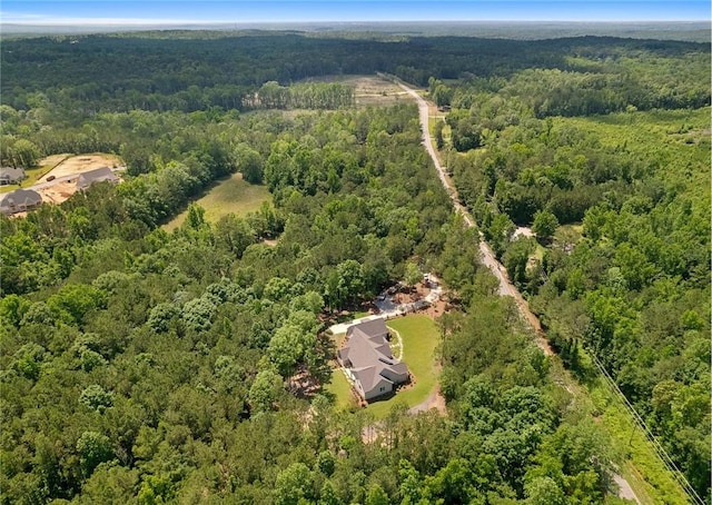 birds eye view of property featuring a view of trees