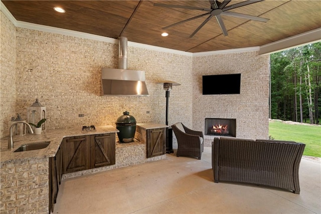 view of patio / terrace featuring an outdoor living space with a fireplace, sink, and ceiling fan