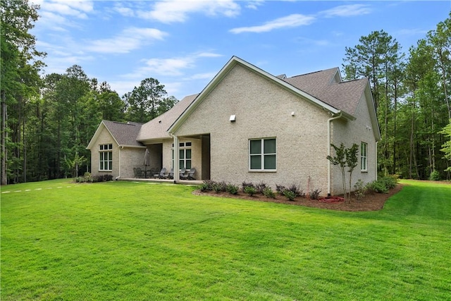 rear view of property featuring a yard