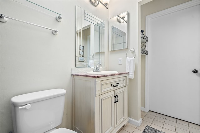 bathroom featuring tile patterned floors, vanity, and toilet