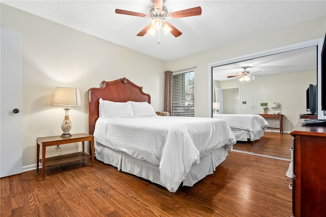 bedroom featuring a textured ceiling, a closet, ceiling fan, and dark hardwood / wood-style floors