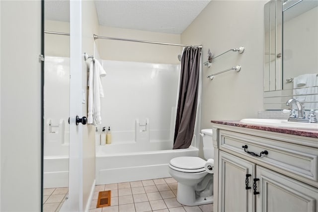 full bathroom featuring vanity, a textured ceiling, shower / tub combo with curtain, tile patterned flooring, and toilet