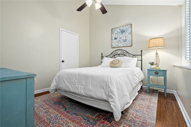 bedroom with lofted ceiling, ceiling fan, and dark wood-type flooring