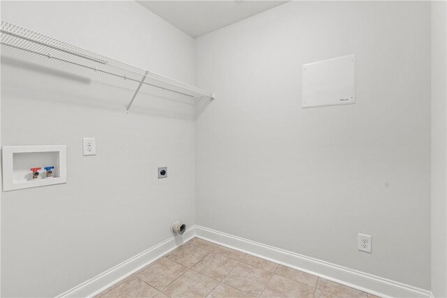 2388 Snowshill Ln, Auburn, AL 36832 - laundry area featuring baseboards, washer hookup, electric dryer hookup, and light tile patterned flooring