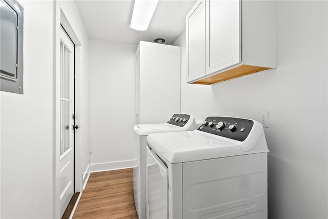 322 Cricket Ln, Auburn, AL 36832 - washroom with cabinet space, washer and dryer, and wood finished floors