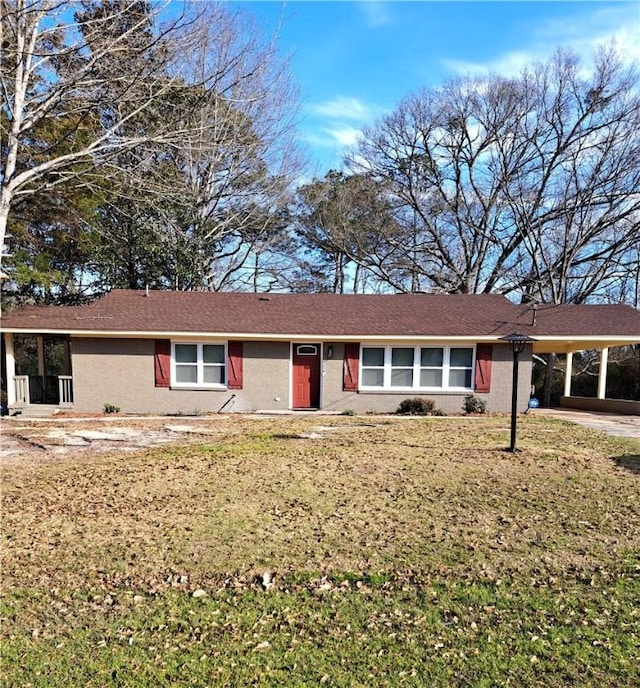 ranch-style home featuring an attached carport and a front lawn