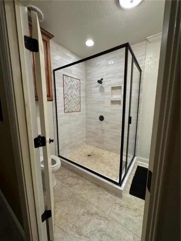 1336 Gatewood Dr, Auburn, AL 36830 - full bathroom with a shower stall, a textured ceiling, toilet, recessed lighting, and tile patterned flooring