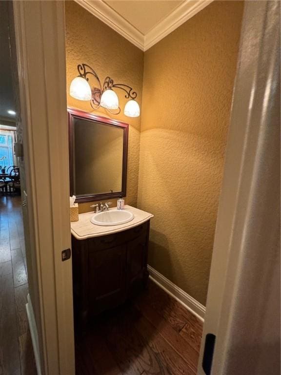 1336 Gatewood Dr, Auburn, AL 36830 - bathroom with a textured wall, wood-type flooring, ornamental molding, vanity, and baseboards