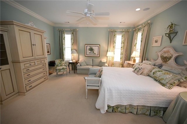 carpeted bedroom featuring ceiling fan and crown molding