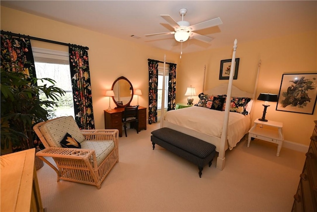 bedroom with carpet, ceiling fan, and multiple windows