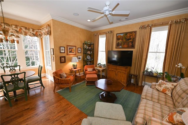 living room featuring dark hardwood / wood-style floors, ceiling fan, and ornamental molding