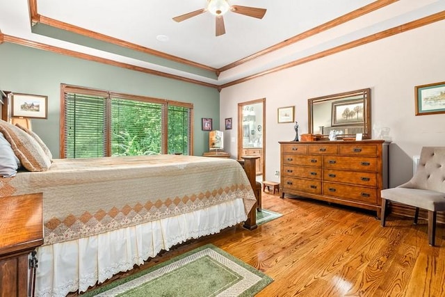 14699 Lee Road 188, Waverly, AL 36879 - bedroom with ornamental molding, a tray ceiling, a ceiling fan, and wood finished floors