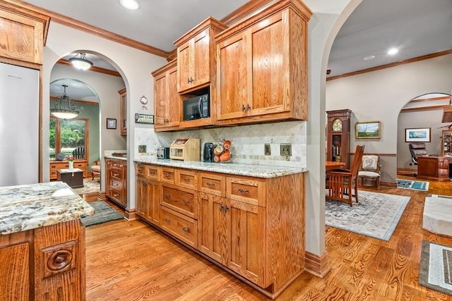 14699 Lee Road 188, Waverly, AL 36879 - kitchen featuring light wood-style floors, black microwave, decorative backsplash, and brown cabinetry