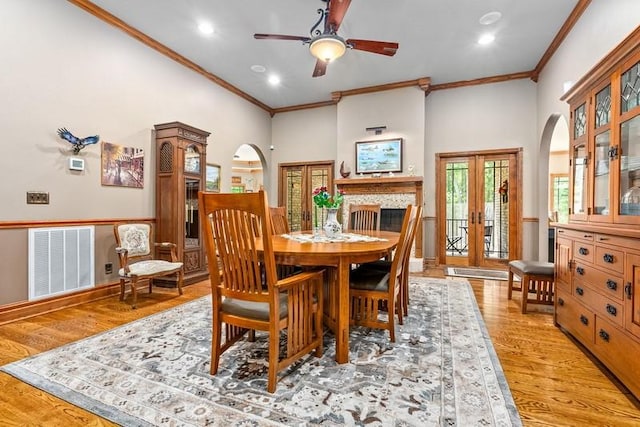 14699 Lee Road 188, Waverly, AL 36879 - dining room featuring arched walkways, wood finished floors, visible vents, french doors, and crown molding