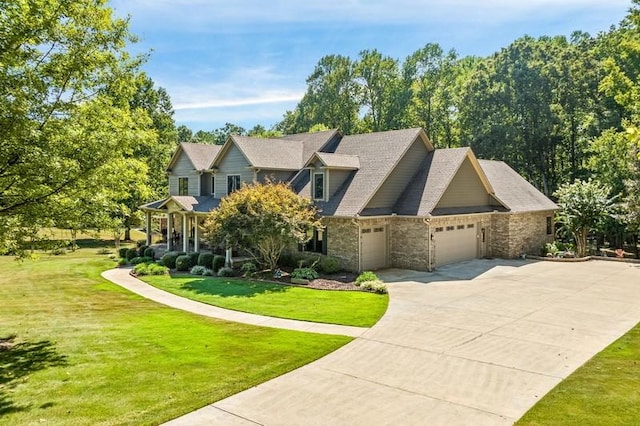 view of front of home with stone siding, a front yard, concrete driveway, and an attached garage