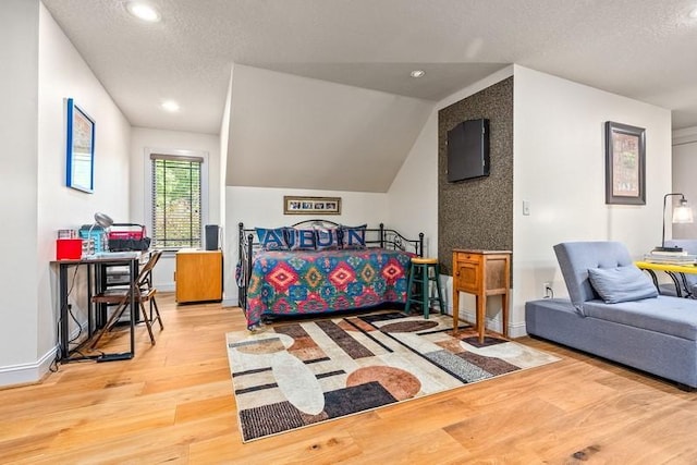 14699 Lee Road 188, Waverly, AL 36879 - bedroom featuring lofted ceiling, a textured ceiling, light wood-type flooring, and baseboards