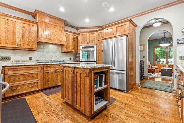14699 Lee Road 188, Waverly, AL 36879 - kitchen featuring arched walkways, ornamental molding, black stovetop, and freestanding refrigerator