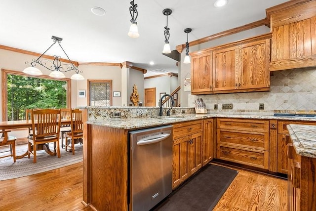 14699 Lee Road 188, Waverly, AL 36879 - kitchen with brown cabinets, crown molding, light wood-style flooring, dishwasher, and a peninsula