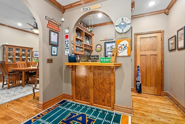 14699 Lee Road 188, Waverly, AL 36879 - bar with baseboards, a dry bar, wood finished floors, and crown molding