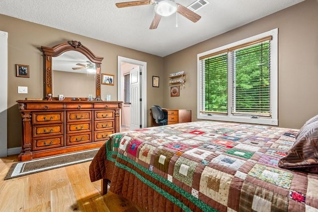 14699 Lee Road 188, Waverly, AL 36879 - bedroom with a textured ceiling, wood finished floors, visible vents, and a ceiling fan