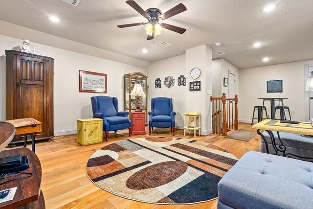 14699 Lee Road 188, Waverly, AL 36879 - living room with light wood-style flooring, baseboards, a textured ceiling, and recessed lighting