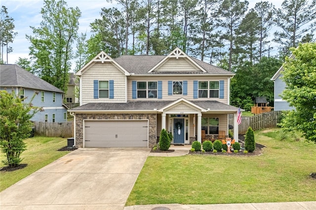 craftsman house with fence, a front lawn, concrete driveway, a porch, and a garage