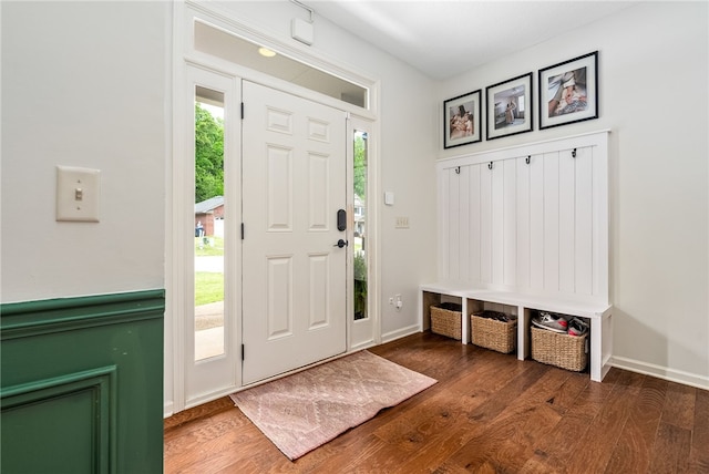 entryway featuring baseboards and wood finished floors