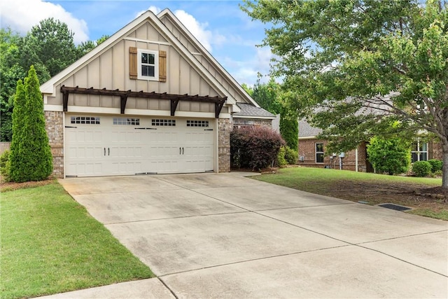 661 Deer Run Rd, Auburn, AL 36832 - craftsman-style house featuring board and batten siding, a front lawn, a detached garage, and stone siding