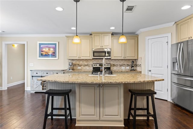 661 Deer Run Rd, Auburn, AL 36832 - kitchen with stainless steel appliances, cream cabinetry, baseboards, ornamental molding, and backsplash