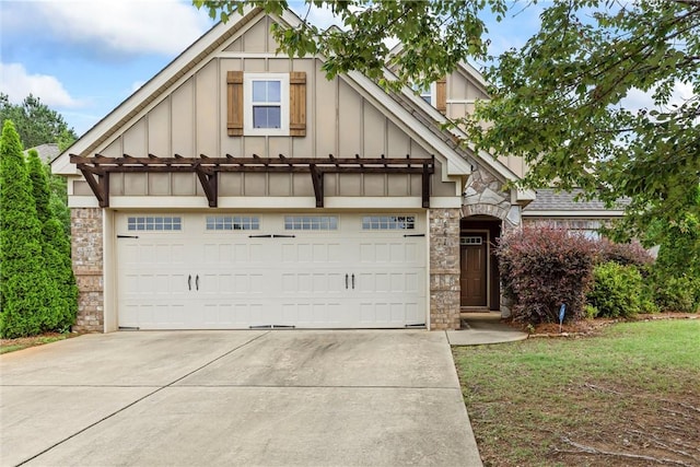 661 Deer Run Rd, Auburn, AL 36832 - view of front of property with board and batten siding, stone siding, driveway, and a garage
