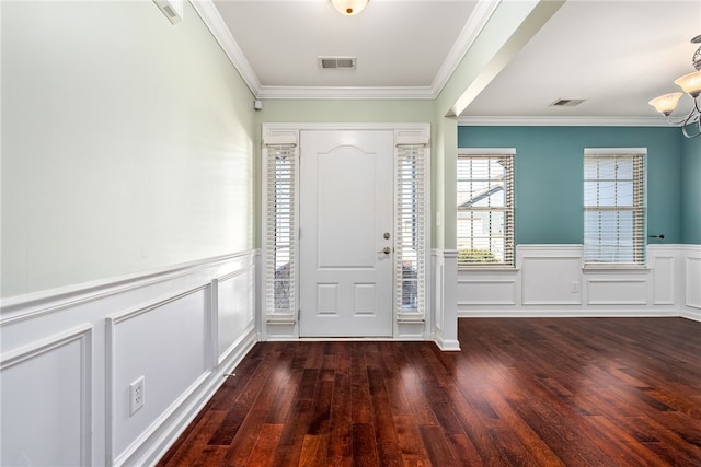 entryway featuring visible vents, wood-type flooring, and ornamental molding