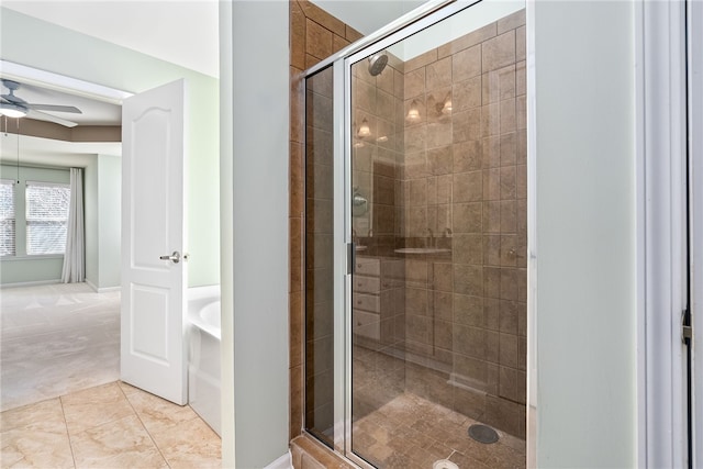 bathroom with tile patterned flooring, a bath, a ceiling fan, and a stall shower