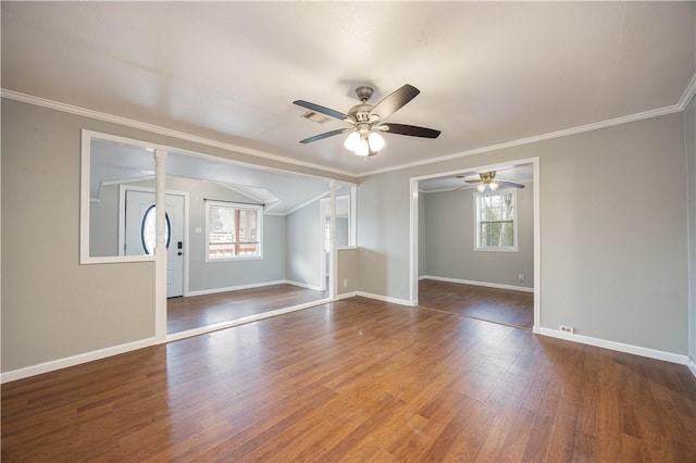 interior space featuring crown molding, dark wood finished floors, a healthy amount of sunlight, and baseboards