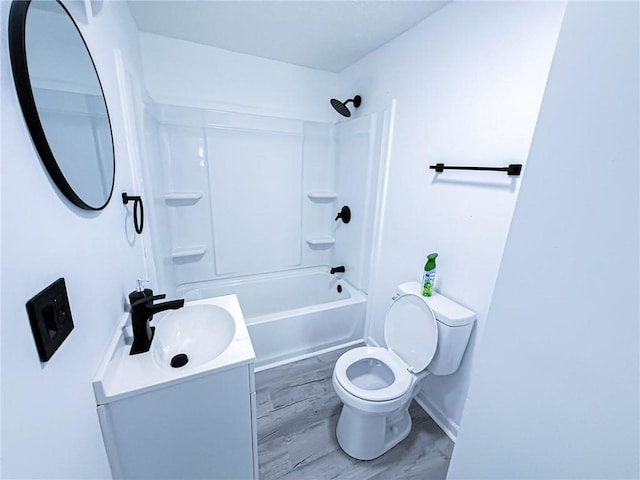 bathroom featuring toilet, shower / bathtub combination, vanity, and baseboards