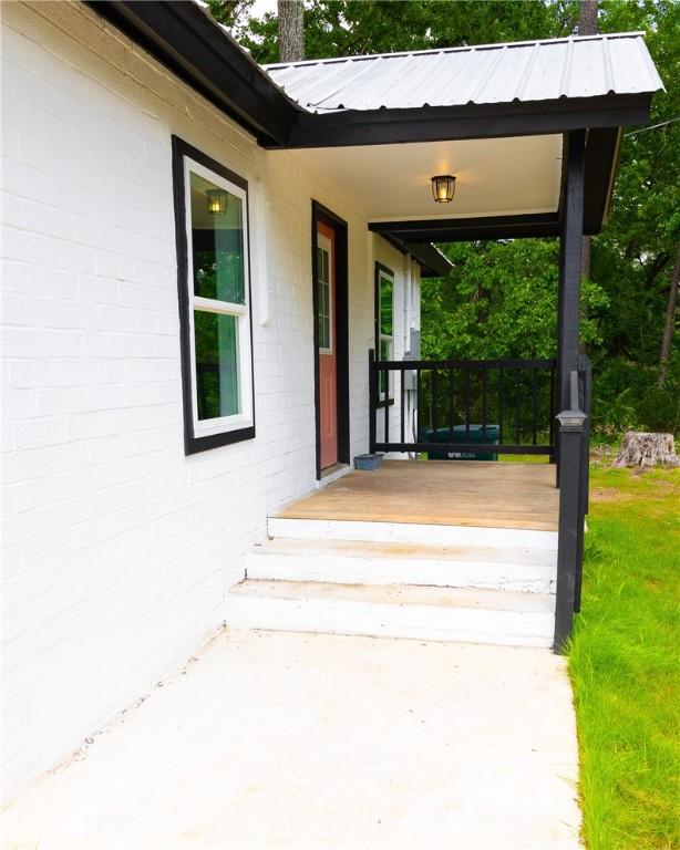exterior space with metal roof and a yard