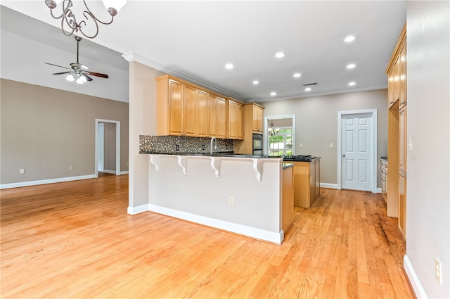 1806 Bluestone Ct, Auburn, AL 36830 - kitchen with a peninsula, ornamental molding, baseboards, light wood-type flooring, and ceiling fan
