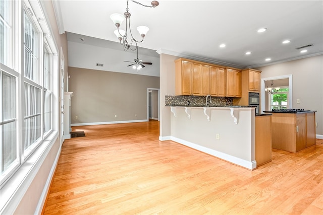 1806 Bluestone Ct, Auburn, AL 36830 - kitchen featuring a chandelier, a ceiling fan, light wood-style flooring, a kitchen bar, and baseboards