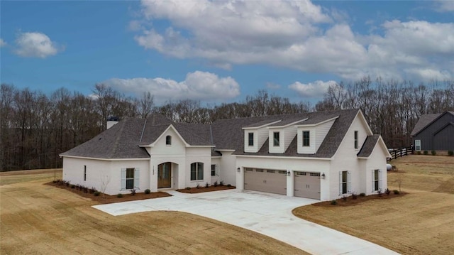 view of front of house with a garage and a front lawn