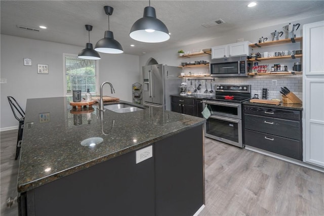 158 Lee Road 242, Phenix City, AL 36870 - kitchen featuring stainless steel appliances, open shelves, a sink, light wood-type flooring, and a textured ceiling