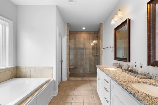 bathroom with tile patterned floors, vanity, and plus walk in shower