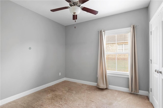 carpeted empty room with ceiling fan and a healthy amount of sunlight