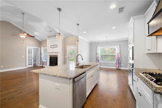 kitchen featuring sink, white cabinetry, stainless steel appliances, and a kitchen island with sink